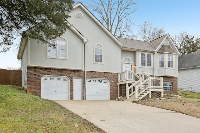 bi-level home featuring a garage and a front lawn