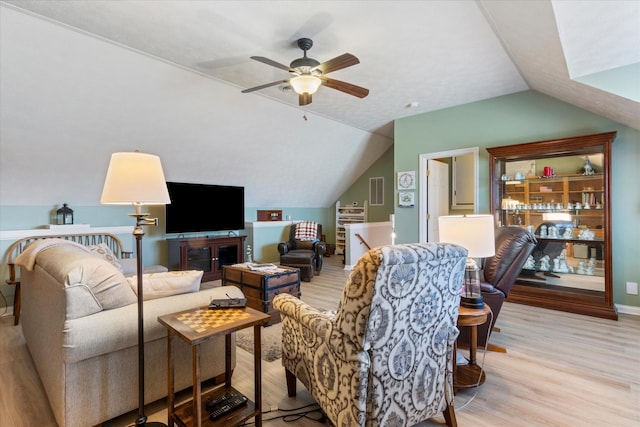 living room with vaulted ceiling, ceiling fan, and light hardwood / wood-style floors