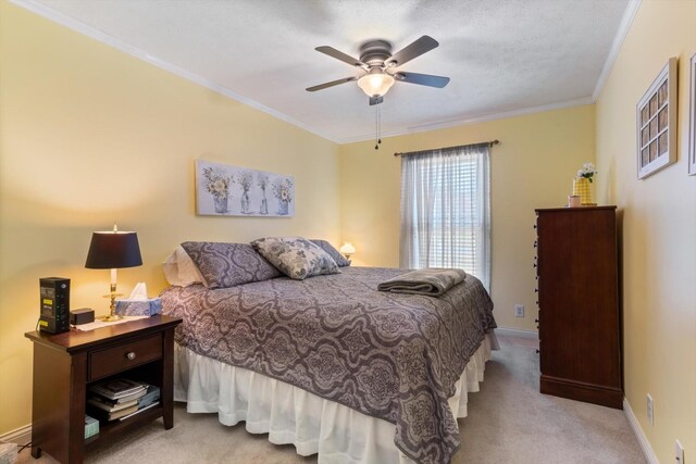 carpeted bedroom featuring crown molding and ceiling fan