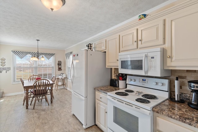 kitchen featuring pendant lighting, white appliances, tasteful backsplash, a notable chandelier, and cream cabinetry