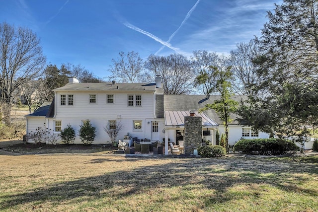 rear view of house featuring a yard and a patio area