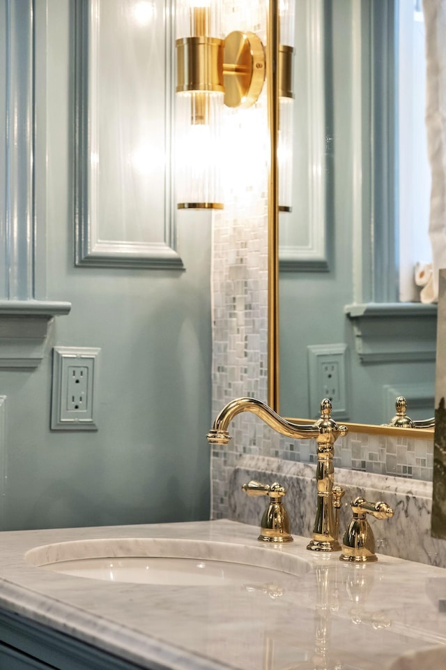 bathroom featuring vanity and decorative backsplash