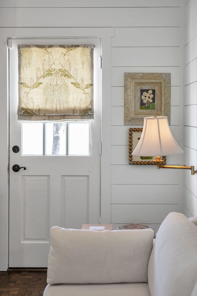 entryway featuring dark parquet flooring