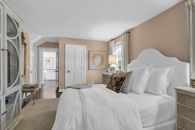 bedroom with hardwood / wood-style flooring and vaulted ceiling