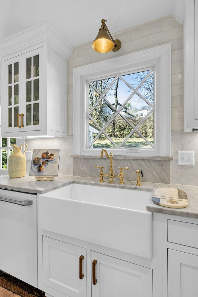 bar featuring white cabinetry, white dishwasher, tasteful backsplash, and a wealth of natural light