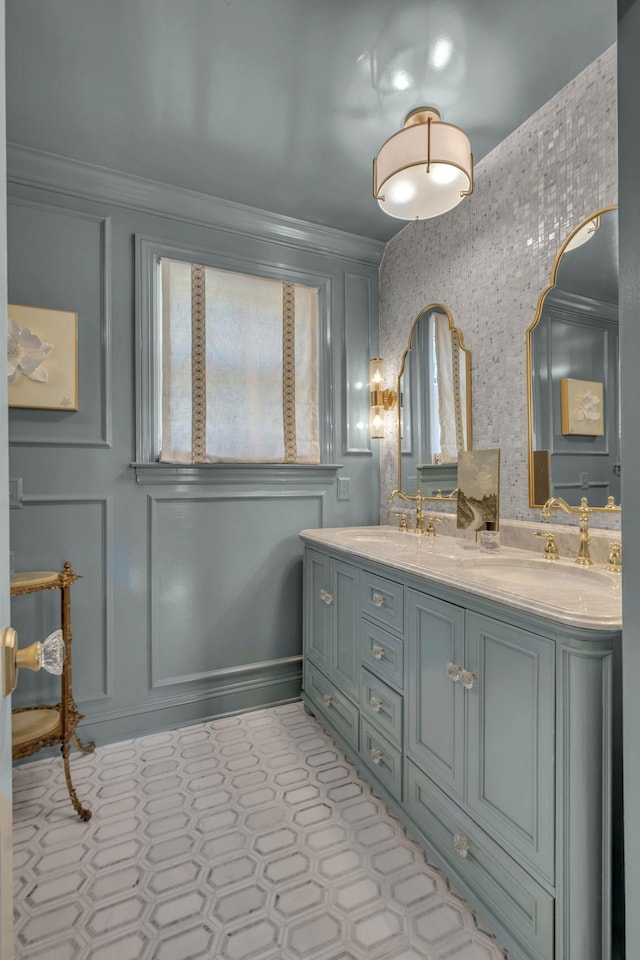 bathroom featuring ornamental molding and vanity