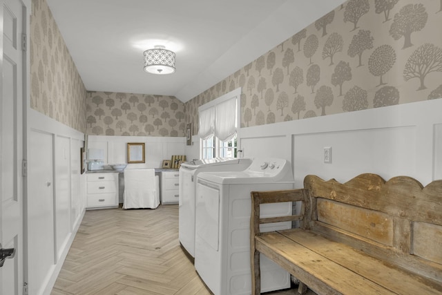 washroom featuring light parquet flooring and separate washer and dryer