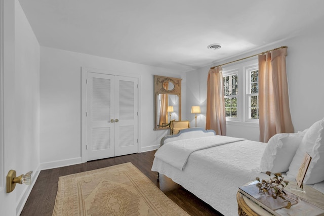 bedroom featuring dark hardwood / wood-style flooring and a closet