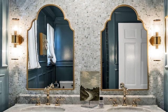 bathroom featuring vanity and decorative backsplash