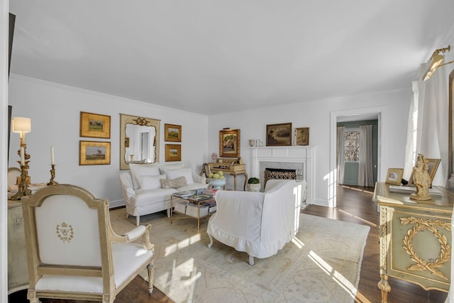 living room featuring dark wood-type flooring and ornamental molding