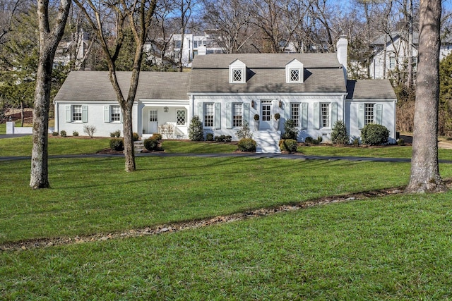 new england style home with a front lawn