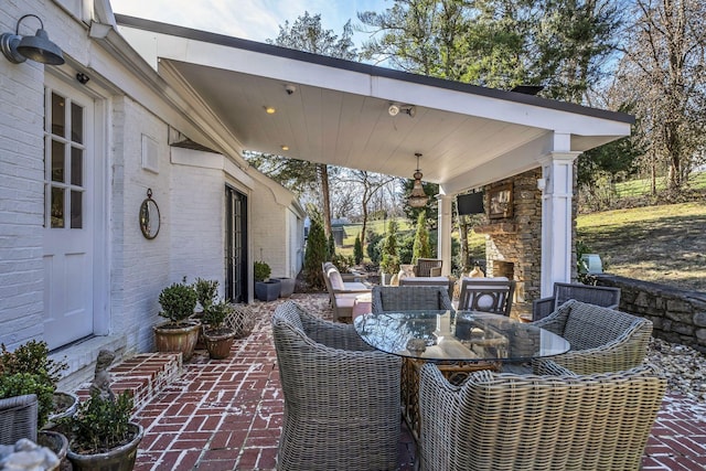 view of patio / terrace featuring exterior fireplace