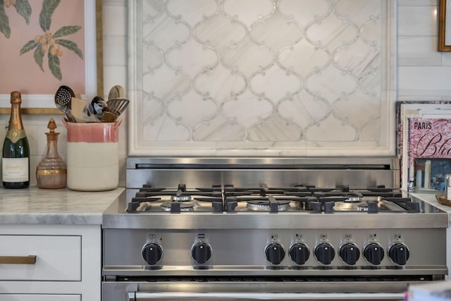 details with light stone counters and stainless steel range with gas stovetop