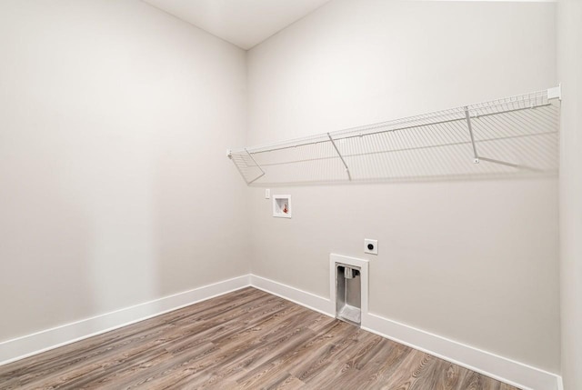 laundry room featuring laundry area, washer hookup, wood finished floors, baseboards, and electric dryer hookup