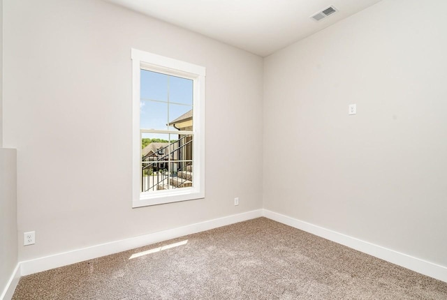 carpeted empty room with baseboards and visible vents