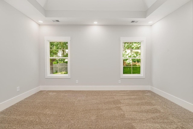 carpeted spare room with plenty of natural light, visible vents, baseboards, and recessed lighting