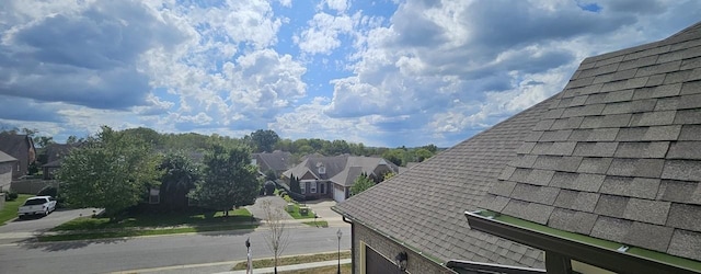 details with a shingled roof and a residential view