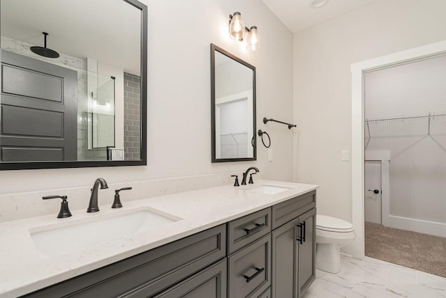 full bath featuring a stall shower, marble finish floor, a sink, and double vanity