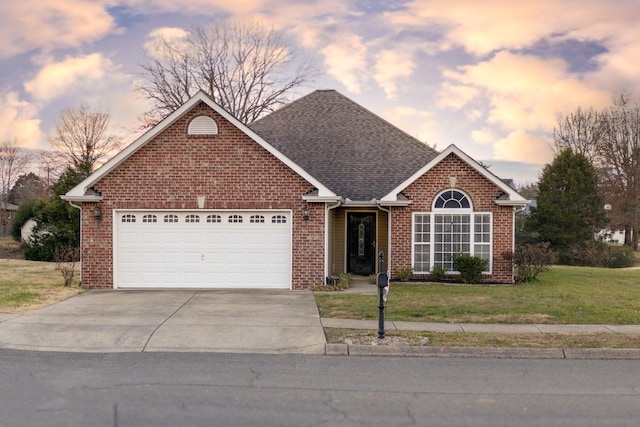 ranch-style house featuring a yard and a garage