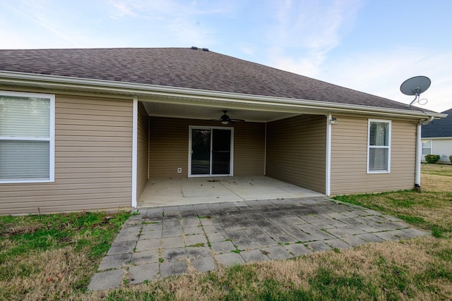 back of property featuring ceiling fan and a patio