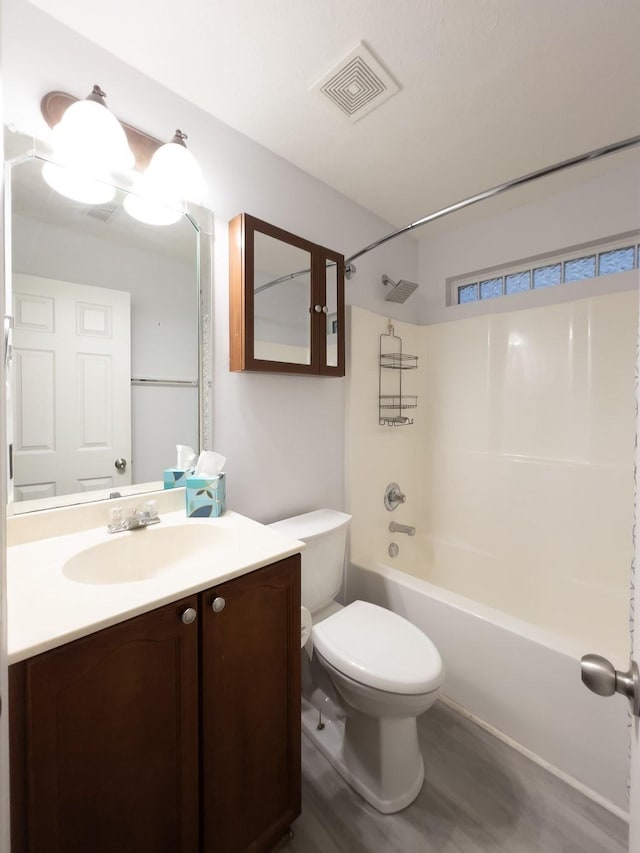 full bathroom with hardwood / wood-style flooring, vanity, bathtub / shower combination, and toilet