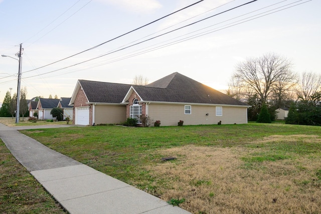 view of home's exterior featuring a garage and a lawn