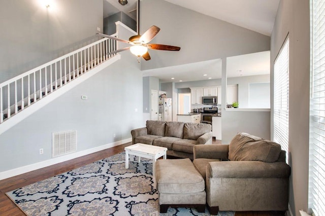 living room featuring ceiling fan, high vaulted ceiling, and dark hardwood / wood-style flooring