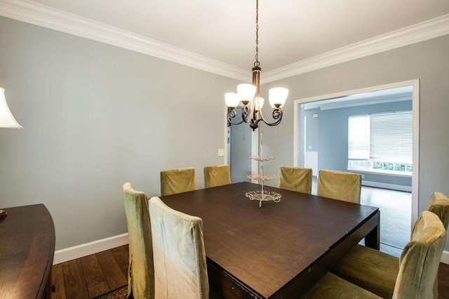 dining space with ornamental molding, dark hardwood / wood-style flooring, and a notable chandelier