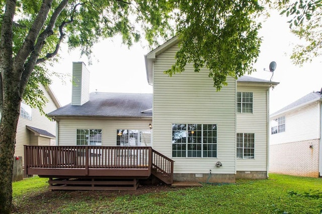 back of house with a wooden deck and a lawn