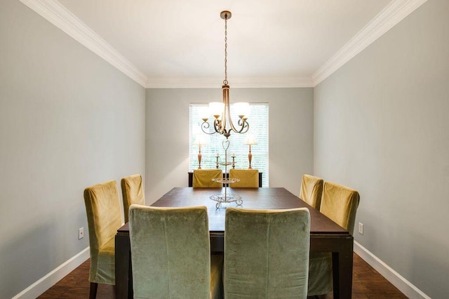 dining space featuring ornamental molding, a chandelier, and dark hardwood / wood-style flooring