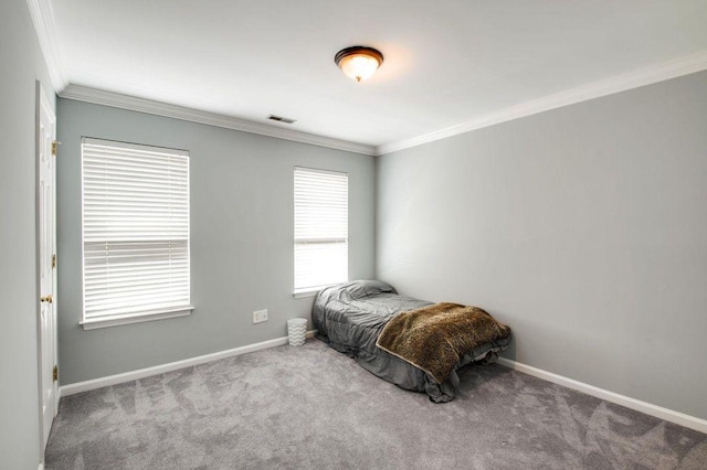 bedroom featuring ornamental molding and carpet