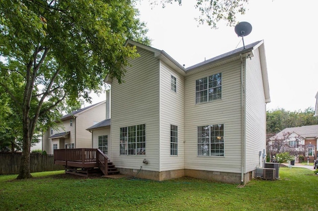 rear view of property featuring a wooden deck, central AC, and a lawn