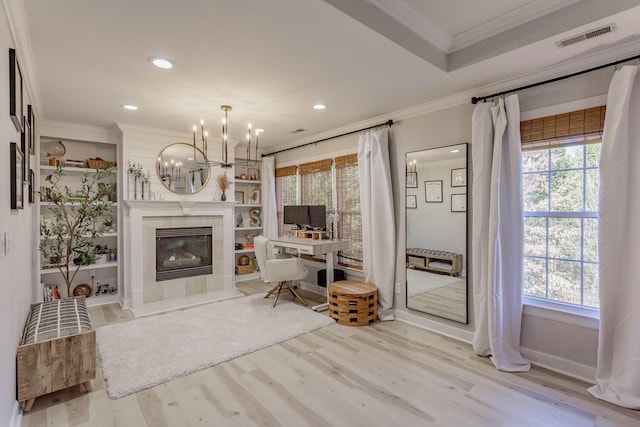 office featuring crown molding, light hardwood / wood-style flooring, and a wealth of natural light