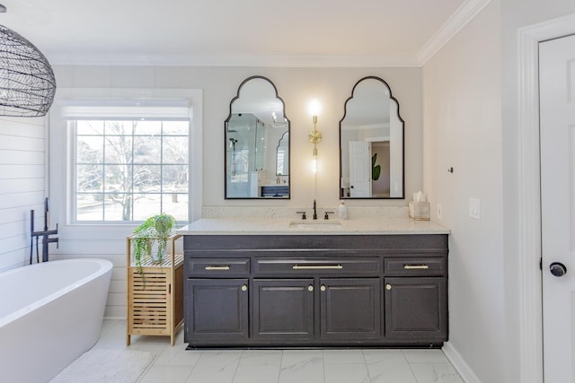 bathroom with a washtub, vanity, and ornamental molding