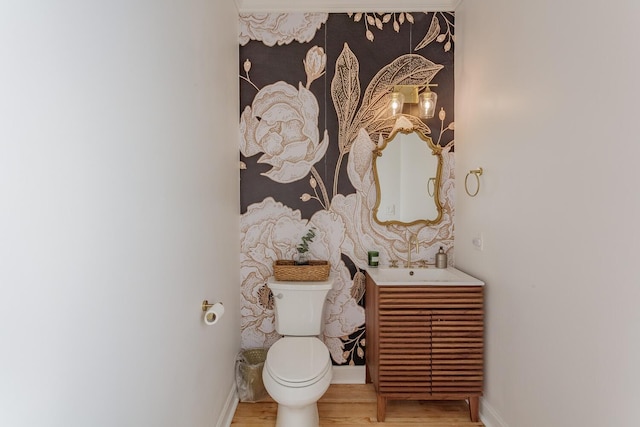 bathroom with sink, hardwood / wood-style floors, and toilet