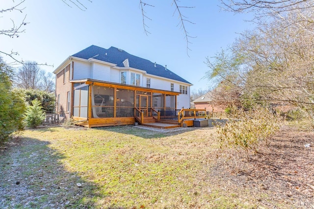 rear view of property with a lawn and a sunroom