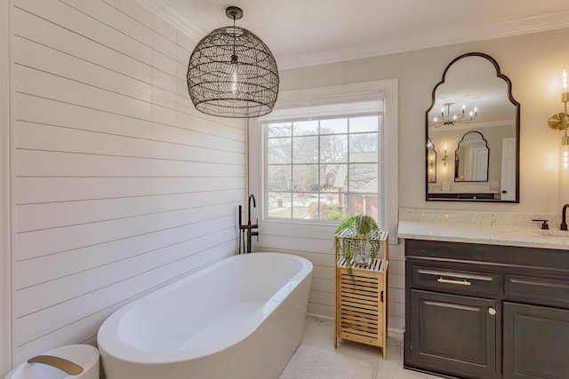 bathroom with crown molding, a tub, and vanity