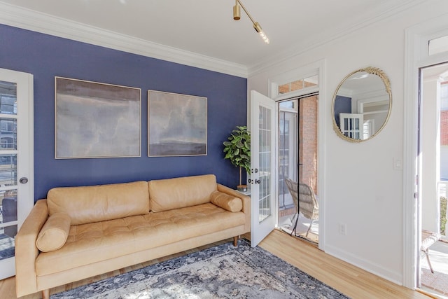 living room with french doors, ornamental molding, and hardwood / wood-style floors