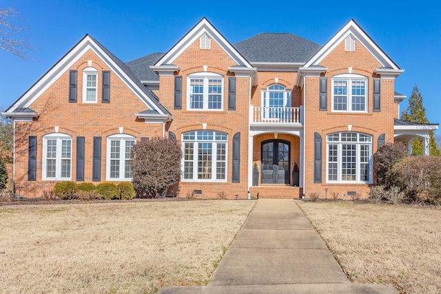 view of property featuring a front lawn and french doors