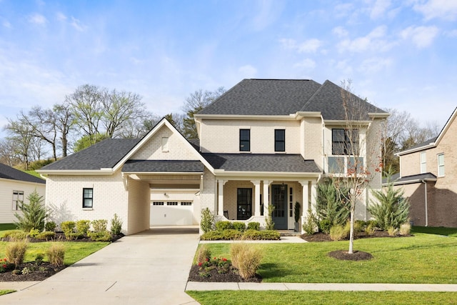 view of front of house featuring a porch, a garage, and a front lawn