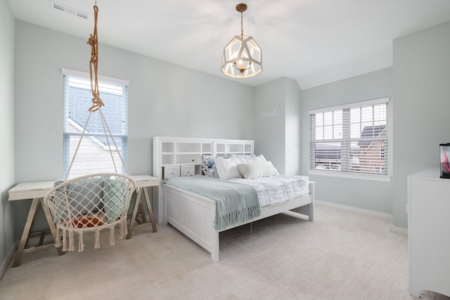 bedroom featuring an inviting chandelier, baseboards, visible vents, and light colored carpet