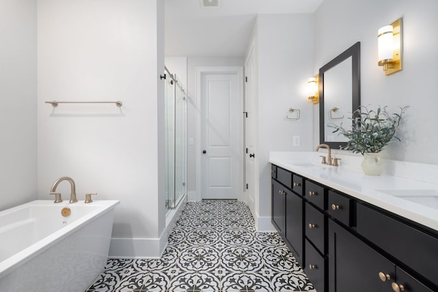 bathroom with a sink, baseboards, a freestanding bath, double vanity, and a stall shower