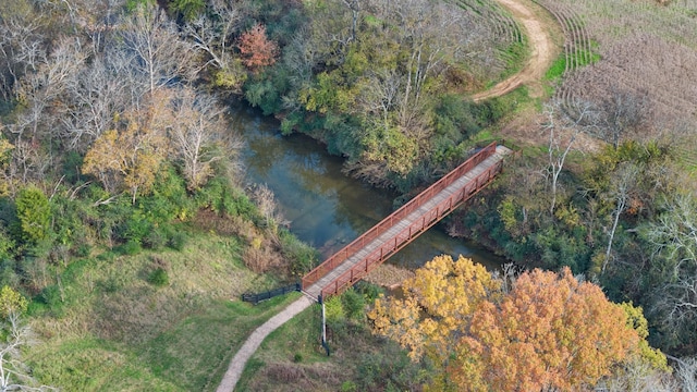 birds eye view of property with a forest view and a water view