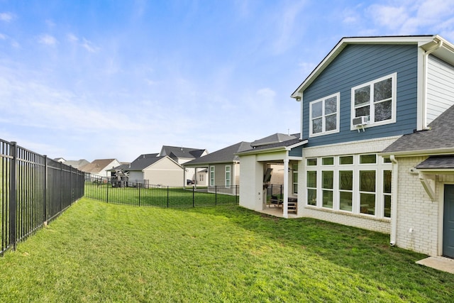 view of yard with a fenced backyard, a residential view, and a patio