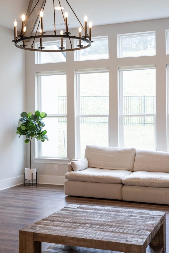 unfurnished living room with baseboards and wood finished floors