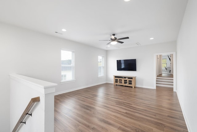 unfurnished living room featuring baseboards, visible vents, wood finished floors, and recessed lighting