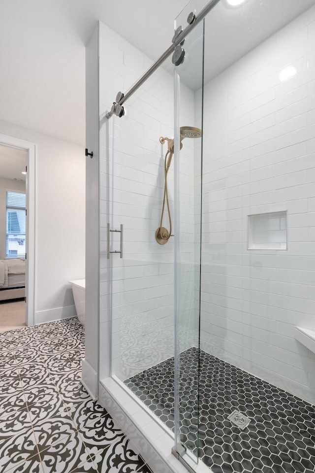 full bathroom with a baseboard radiator, a freestanding tub, connected bathroom, baseboards, and a stall shower