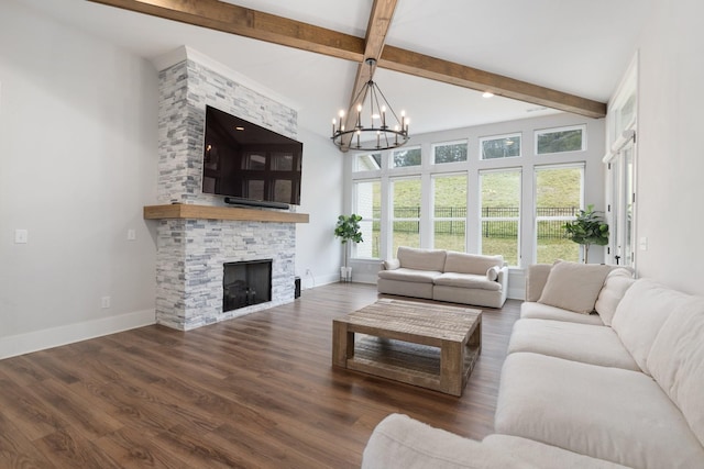 living area featuring beam ceiling, baseboards, wood finished floors, and a stone fireplace