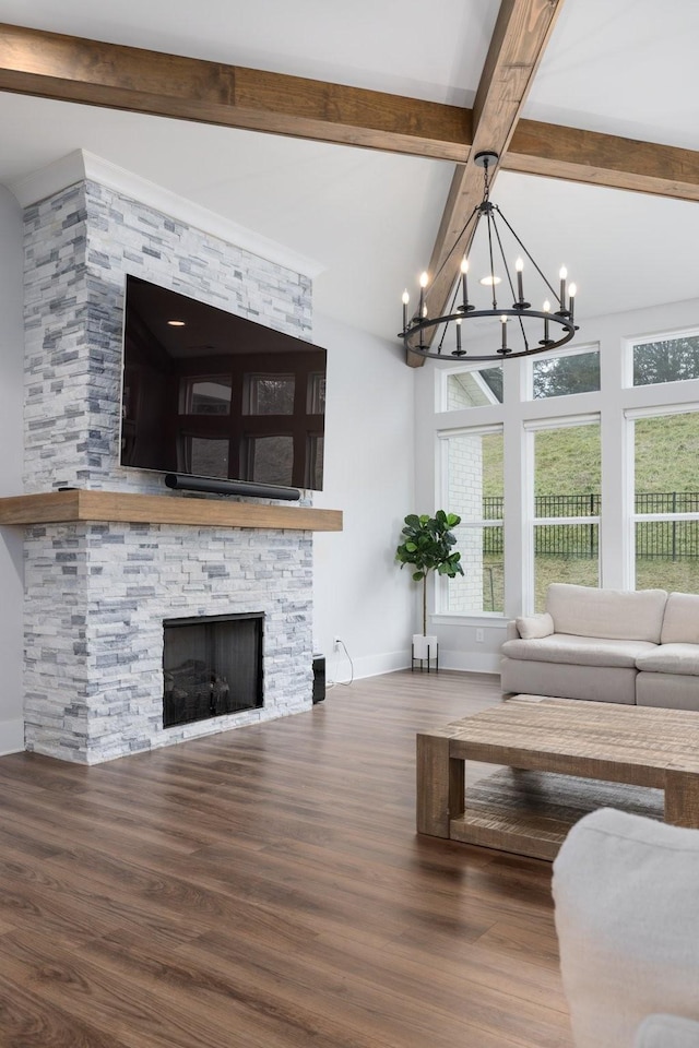 unfurnished living room with a fireplace, plenty of natural light, baseboards, and wood finished floors