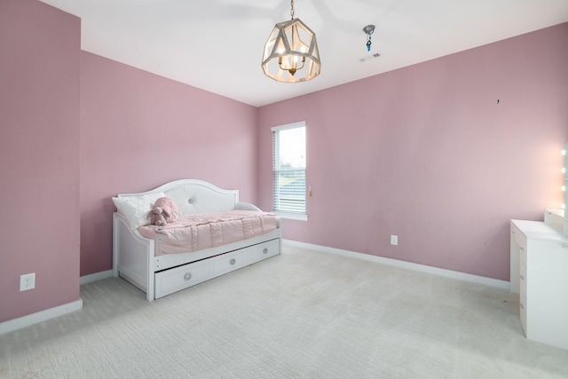 carpeted bedroom with an inviting chandelier, baseboards, and visible vents